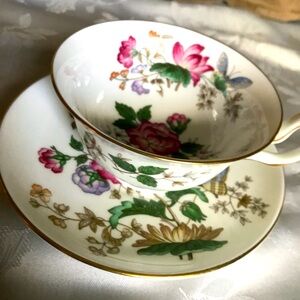 Wedgwood bone china cup and saucer. Cup is covered in flowers inside and out